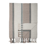 Striped woven throw with fringe.